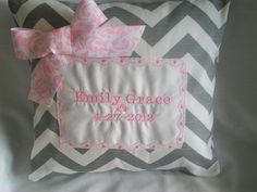 a gray and pink pillow with a name tag on the front that says, family grace 2012