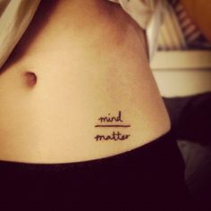 a woman with a small tattoo on her stomach