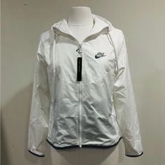 Nike Sportswear Windrunner Jacket Womens Size S Msrp: $90.00 + Tax New With Tags In Packaging Size: S Sku: Bv3939-100 Colors: White Lightweight And Cool, The Nike Windrunner Jacket Delivers Coverage For Your Run. Benefits: Sweat-Wicking Technology Helps You Stay Dry And Comfortable. Product Details: Loose Fit For A Relaxed, Easy Feel Full Zip With Zip Guard Elastic Cuffs Reflective Swoosh Logo On The Left Chest And Reflective-Design Graphic On The Lower Back Machine Wash Imported Not Intended Fo White Nike Long Sleeve Activewear, Nike White Long Sleeve Activewear, White Hooded Activewear For Outdoor, White Hooded Outdoor Activewear, White Technical Windbreaker For Streetwear, Technical White Windbreaker For Streetwear, White Nylon Track Jacket With Moisture-wicking, White Sports Windbreaker, White Moisture-wicking Track Jacket For Spring