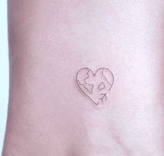 a small heart tattoo on the ankle