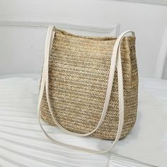 Carry Summer Wherever You Go Introducing our Bohemian Straw Woven Shoulder Bag, your new favorite summer accessory that combines effortless style with functional design. Perfect for beach getaways, sunny market days, or any casual outing, this handcrafted bag is as versatile as it is beautiful, ensuring you carry a piece of summer with you wherever you go. Key Features High-Quality Straw Material: Meticulously woven from the finest straw, this bag offers durability while staying lightweight, making it ideal for all-day wear. Compact Yet Spacious: With dimensions of 25*25*12 cm, it provides ample space for your essentials without being bulky. Secure Hasp Closure: Keeps your belongings safe with an easy-to-use hasp closure that adds an elegant touch to the bag's overall design. Benefits of O Summer Beige Bucket Shoulder Bag, Summer Beige Tote Shoulder Bag, Summer Beige Crochet Shoulder Bag, Beige Summer Bag For Daily Use, Beige Rectangular Summer Shoulder Bag, Beige Rectangular Shoulder Bag For Summer, Beige Shoulder Bag For Vacation, Trendy Straw Shoulder Bag For Daily Use, Beach Season Hobo Shoulder Bag For Daily Use