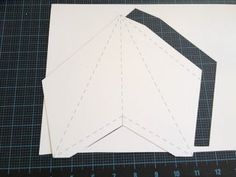 two pieces of paper cut out to look like an airplane