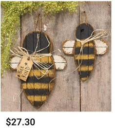 two bees are hanging on the side of a wooden fence with a price tag attached to them