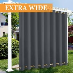 an extra wide window curtain in front of a house with the words extra wide on it