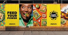 an advertisement on the side of a building with food in it's mouth and words feed your power