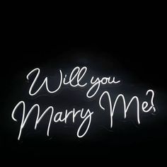 a neon sign that says will you marry me? in white writing on a black background