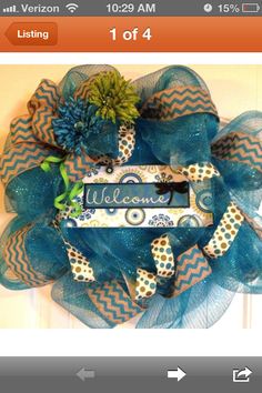 a blue and orange mesh wreath with the word welcome hanging from it's center