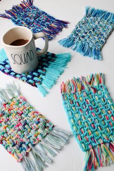 crocheted placemats and coffee cup holders on a table with one mug in the middle