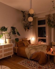 a bed room with a neatly made bed and lots of plants