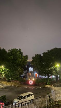 a car parked in front of a building at night