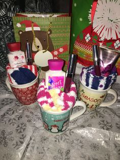 three mugs with various items in them sitting on a table