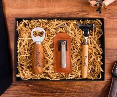 two bottle openers in a gift box with corkscrew and leather keychain