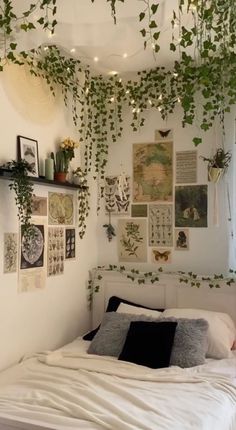 a bed with lots of plants hanging from the ceiling