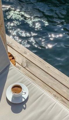 a cup of coffee sitting on top of a white saucer