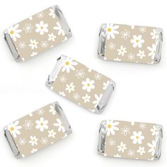 four pieces of chocolate with white flowers on brown and white background, set of 4