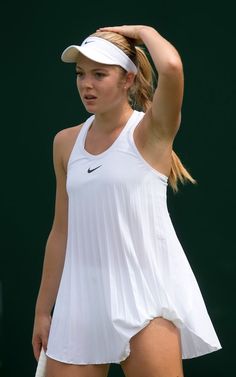 a female tennis player is holding her racket