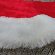 a white and red santa hat laying on top of a wooden table