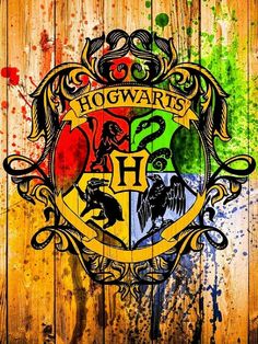 the hogwarts crest painted on a wooden wall