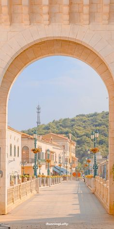 an archway leading into a town with lots of buildings