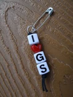 the word i love you spelled with letters and a red heart hanging from a hook