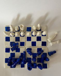 blue and white chess pieces laid out on a table