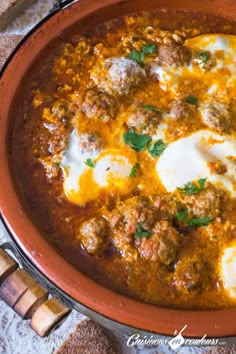 a large pot filled with meat and eggs