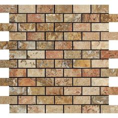 a brick wall that is made up of different colors and shapes, including brown, beige and