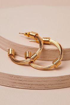 Elevate any look the instant you pair it with the Lulus Beautiful Intention 14KT Gold Wire Hoop Earrings! These gorgeous earrings are plated in genuine 14KT gold and have a wire-like design, with a slender profile and a classic hoop silhouette. Coiled details accent the ends. This item is plated with real 14KT gold. Love it and it will love you back! Remove before exercising or showering, and when applying scents, lotions and sprays. Post backs. 1. 25" In Diameter. 100% 14KT Gold Dipped Brass. Imported. Lulus | Beautiful Intention 14KT Gold Wire Hoop Earrings. Gold Small Hoop Wrap Earrings Trendy, Trendy Small Hoop Gold Wrap Earrings, Trendy Wire Wrapped Gold Jewelry, Wire Wrapped Yellow Gold Hoop Earrings, Gold Hoop Nickel-free Wrap Earrings, Nickel-free Gold Hoop Wrap Earrings, Gold Wire Wrapped Hoop Earrings, Modern Gold Wire Wrapped Hoop Earrings, Adjustable Gold Hoop Wrap Earrings