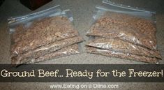 two bags of brown ground beef sitting on top of a counter next to each other