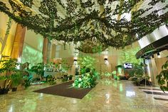 the lobby is decorated with plants and lights