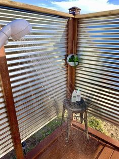 an outdoor shower with water coming out of the faucet