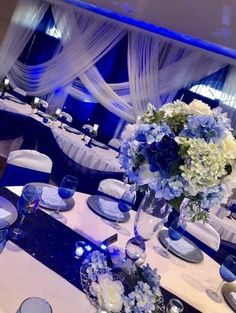 the table is set with blue and white flowers