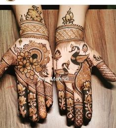 two hands with henna tattoos on them, one is decorated and the other is painted