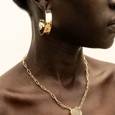 A fresh take on gold hoops: bold, yet sleek. The Maji Hoops are grounding and will have you feeling your most confident. With a handcrafted hammered effect, these earrings were responsibly made by our artisan partners in Kenya using traditional techniques in 24K gold-plated brass. Dimensions: Internal Diameter: 1.65in (42mm)Width of the hoop: 0.39in (10mm) Hammered Gold-plated Hoop Jewelry, Hammered Gold Plated Hoop Jewelry, Hammered Gold-plated Hoop Earrings, Hammered Gold-plated Small Hoop Earrings, Hammered Gold Plated Hoop Earrings, Small Gold Plated Hammered Hoop Earrings, Small Hammered Gold-plated Hoop Earrings, Yellow Gold Hammered Metal Hoop Earrings, Modern Gold Hammered Hoop Earrings