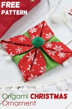 an origami christmas ornament is on the table