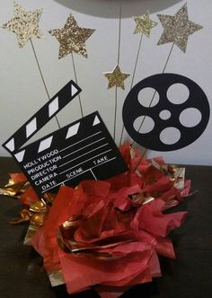 a black and white film reel with red tissue flowers