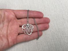 "This is such a fun and unique silver flower necklace. It is modern and whimsical in it's detail and design. Perfect for everyday wear and very versatile in style. The pendant measures 1 1/4\" long by 1\" wide and hangs from a simple 18\" stainless steel necklace chain. I have matching earrings in my shop, if you would like the whole set. Here is the link https://etsy.me/2A7CZDF Thanks for stopping by! Please take a moment and visit the rest of my Etsy shop. I have many more unique jewelry desig Silver Pendant Flower Necklace Nickel Free, Whimsical Silver Flower Jewelry, Adjustable Silver Charm Necklace With Flower Pendant, Silver Charm Necklace With Flower Pendant, Hypoallergenic Silver Necklace With Flower Pendant, Silver Flower Pendant Necklace With Adjustable Chain, Silver Metal Necklace In Flower Shape, Silver Hypoallergenic Flower Necklace, Silver Metal Flower Pendant Necklace