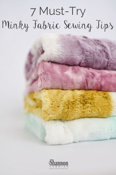 four different colored towels stacked on top of each other with text overlay that reads, 7 must - try minky fabric sewing tips