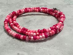 This stylish boho glass beaded necklace or bracelet is made of size 6/0 Czech glass seed beads in a variety of pink tones, and is shown finished with a lobster claw clasp, but can also be finished with a screw closure that blends in when you wrap it as a necklace or bracelet if you select a long enough size! The clasp is also available in gold and bronze.  * Main Color: Pink - light pink, magenta, strawberry, bubblegum pink * Material: small Czech glass seed beads approximately 3.5mm in size 𝗔? Pink Hand-strung Beaded Necklaces For Festival, Festival Pink Hand-strung Beaded Necklaces, Festival Hand-strung Pink Beaded Necklaces, Hand-strung Pink Beads For Festivals, Pink Hand-strung Beaded Necklaces For Beach, Pink Hand-strung Beaded Necklace For Beach, Adjustable Pink Beaded Necklace With 108 Beads, Pink Beaded Necklaces For Beach, Pink Beaded Necklace With 108 Beads For Beach