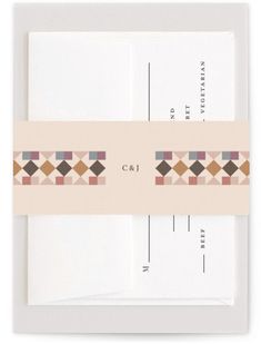 two white envelopes with brown and pink geometric designs on the inside one is blank