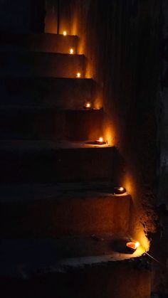 stairs lit up with candles in the dark