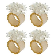 four pieces of jewelry with flowers on them