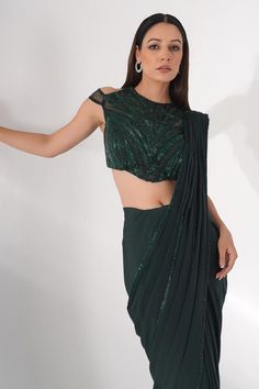 Green lycra pre-draped saree with pleated draped detail and attached embroidered pallu. Paired with padded blouse with all over tonal cut dana, pearl and bead embroidery.
Components: 2
Pattern: Embroidered
Type Of Work: Bead, Stone, and Cut Dana Work
Neckline: Closed Neck
Sleeve Type: Cold Shoulder Sleeves
Fabric: Lycra
Color: Green
Other Details: 
Embroidered sheer back
Pointed blouse hem
Saree Length: 44 inches
Occasion: Cocktail,Sangeet - Aza Fashions Fitted Blouse With Cape Sleeves For Party, Fitted Cape Sleeves Blouse For Party, Party Tops With Sequins And Traditional Drape, Fitted Evening Blouse With Cape Sleeves, Georgette Tops For Party With Traditional Drape, Evening Blouse With Sequins In Traditional Drape, Party Tops In Georgette With Traditional Drape, Evening Blouse With Sequins And Traditional Drape, Sequin Blouse With Traditional Drape For Evening