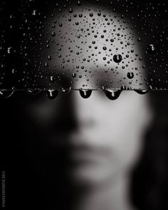 a woman's face with water droplets on it