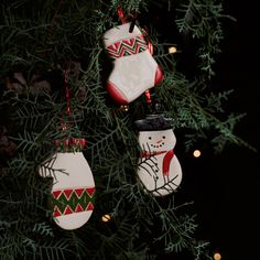 three christmas ornaments hanging from a tree