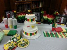 a table topped with a multi layer cake next to other desserts and decorations on top of it