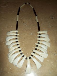 This necklace measures 25" long with clasp. I chose black buffalo horn beads the color of the spirits world and white buffalo bone beads the color of purity. Each tooth unique largest teeth are a little over 2" total of 20 buffalo teeth. NO INTERNATIONAL SHIPPING ARTIST NAME: Aodhàn Crawford TRIBAL AFFILIATION: Cherokee Your item comes with Certificate of Native American Made/Celtic Made Authenticity Indian Arts And Crafts, Tooth Necklace, Tacoma Wa, The Buffalo, Bone Beads, White Buffalo, Native American Art, American Made, Native American