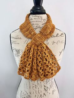 a crocheted scarf on top of a mannequin