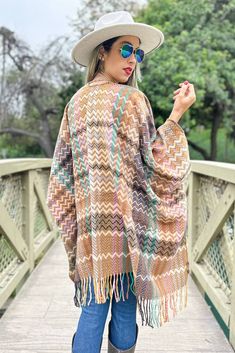 100% Acrylic; Add a vibrant touch to your wardrobe with our boho chevron print, open ruana-- finished with chic fringe detailing along the hem for a Bohemian vibe. It has a relaxed, flowing fit that flatters all body types, and no matter how you style this one babe, it's a Win! Spring Multicolor Tassel Shawl, One Size Poncho For Vacation In Fall, One Size Poncho For Fall Vacation, One Size Fall Poncho For Vacation, Oversized Bohemian Outerwear With Fringe, Multicolor Fringe Shawl For Spring, Spring Multicolor Shawl With Fringe, Spring Multicolor Fringe Shawl, Oversized Bohemian Shawl With Fringe