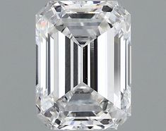 an emerald cut diamond on a gray background with the center stone in white and black